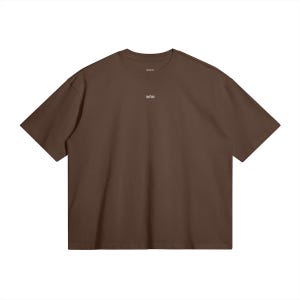 May include: A solid brown t-shirt with short sleeves. The shirt has a crew neck and the word "WRN" is printed in small white letters on the chest. The shirt is made of a soft material and is a basic wardrobe staple.