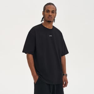 May include: Black short-sleeved t-shirt with the white text "WRN" centered on the chest. The shirt has a relaxed fit and is worn by a person. The person is wearing a watch on their left wrist.