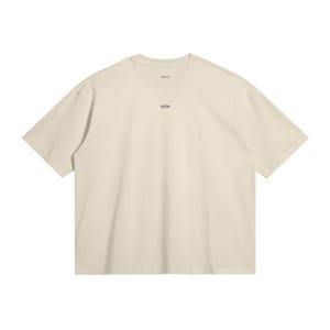 May include: Cream-colored short-sleeved t-shirt with the text "WRN" printed in black near the neckline. The shirt has a relaxed fit and a simple, minimalist design. The fabric appears to be a soft, breathable material.