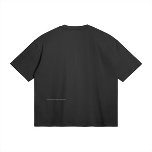 May include: A black t-shirt with short sleeves. The text "STRUCTURED FORM / ESSENTIAL" is printed in white near the bottom. The shirt is made of a soft, comfortable material.