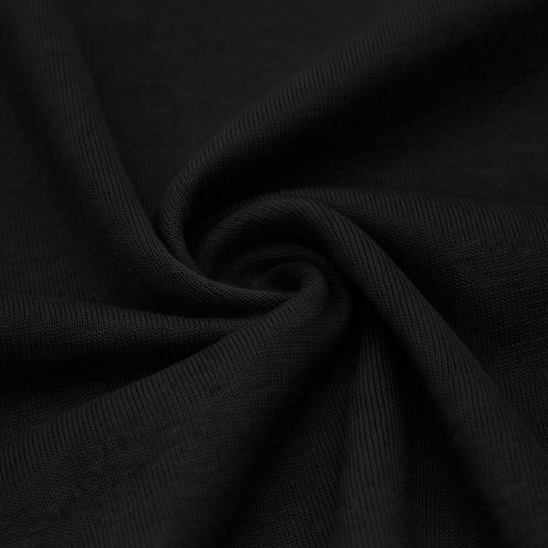 May include: Close-up of black fabric with a ribbed texture. The material is tightly woven and appears to be soft and flexible, with visible folds and shadows. The fabric is a solid, deep black color.
