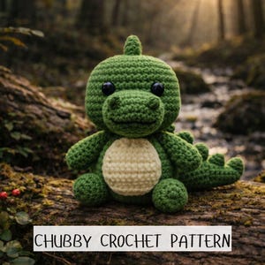 May include: A handmade green crochet dinosaur toy with a cream belly, black eyes, and a small fin. The text "CHUBBY CROCHET PATTERN" is displayed. The toy is sitting on a log in a forest setting.