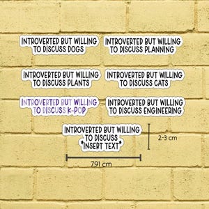 May include: A set of white stickers with purple borders and black text. The stickers say: "Introverted but willing to discuss..." followed by topics such as dogs, planning, plants, cats, K-pop, and engineering. The longest sticker is 7.91 cm.