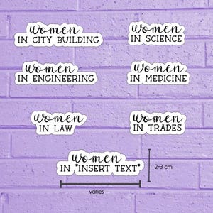 May include: A selection of white stickers with black text on a purple brick background. The stickers read "Women in City Building," "Women in Science," "Women in Engineering," "Women in Medicine," "Women in Law," "Women in Trades," and "Women in *Insert Text*."