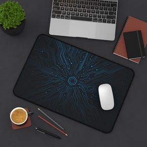 May include: Black rectangular mouse mat featuring a blue circuit board pattern. A white computer mouse is on the mat. A laptop, coffee cup, pencils, and notebooks are also visible.