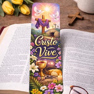 May include: A colorful bookmark with the words "Cristo Vive" features a cross, doves, and flowers. The bookmark is placed in an open book with a red spine, next to a cup of coffee and a pair of glasses.