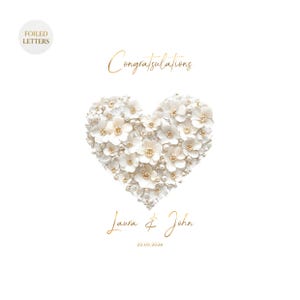 A white greeting card with a heart shape made of small white flowers and pearls, with gold foil text reading "Congratulations" above and "Laura & John 20.05.2026" below, on a white background.