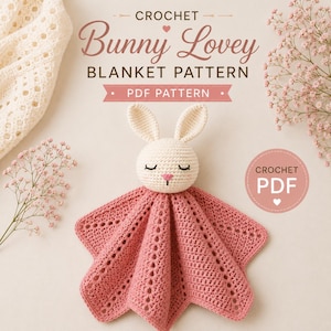 May include: A crochet bunny lovey blanket pattern PDF featuring text that reads Crochet Bunny Lovey Blanket Pattern PDF Pattern. The image shows a cream-colored crocheted bunny head with a pink nose and closed eyes attached to a dusty pink star-shaped blanket.