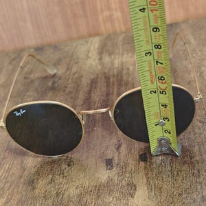 May include: A handmade, wooden cutting board with a natural finish. The board features a live edge, showcasing the wood's unique grain and shape. It is approximately 18 inches long and 12 inches wide.