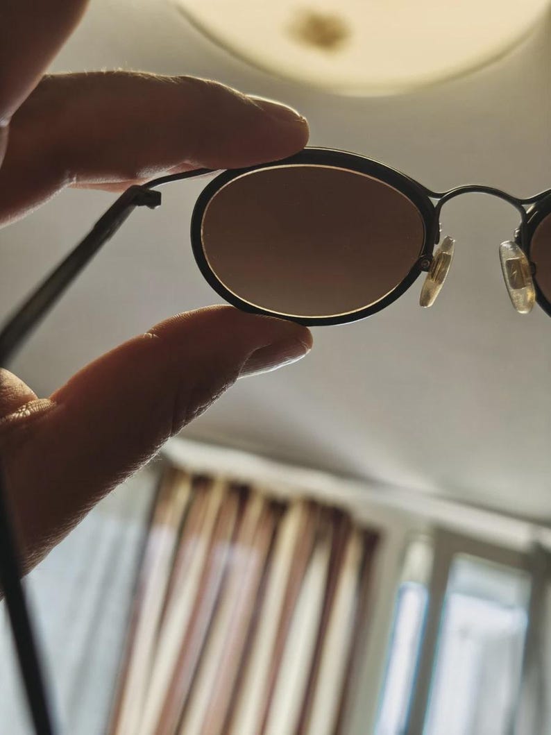 May include: A set of three ceramic mugs with a speckled, matte finish. The mugs are in shades of cream, light gray, and dark gray. Each mug has a simple, minimalist design and a rounded handle.