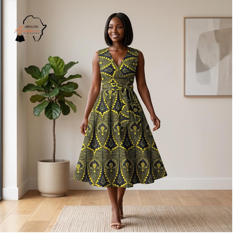 May include: A sleeveless, knee-length dress with a V-neck and a wrap-style bodice. The dress features a yellow and black geometric pattern and a matching belt. The dress is from Umulisa Clothing.