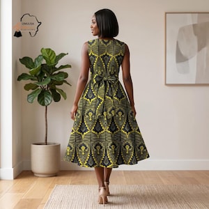 May include: A sleeveless, knee-length dress with a yellow and black geometric pattern. The dress features a bow at the waist and a flared skirt. The model is wearing nude heels. The dress is from Umulisa Clothing.