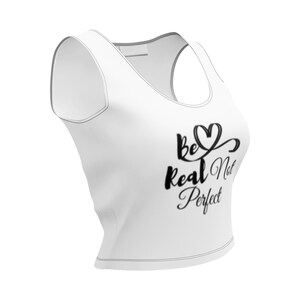 May include: White crop top with a scoop neck and racerback design. The shirt features the text "be Real Not Perfect" in black script. The top is made of a soft, lightweight material.