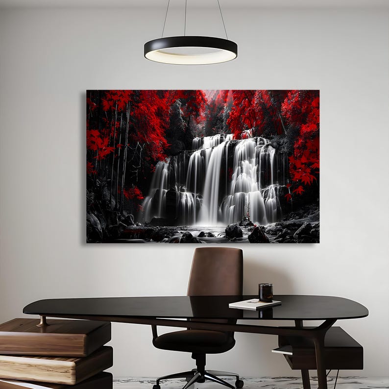 May include: A large canvas print of a waterfall scene. The image is primarily black and white, with vibrant red foliage accenting the top and sides. The waterfall cascades down rocks, creating a striking contrast.