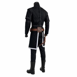 May include: Black costume with white stitching, featuring a quilted jacket with short sleeves, matching pants, and a brown leather belt with a pouch. The outfit includes black boots and a holster. The costume is designed for cosplay or themed events.