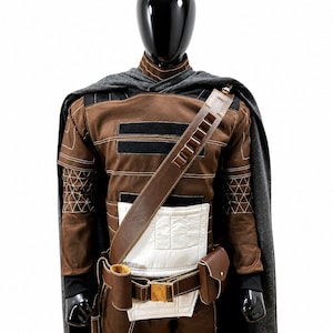 May include: A brown and black costume displayed on a mannequin. The costume includes a brown jacket with black accents, a gray cape, and a brown leather belt with pouches. The jacket has geometric stitching details. The costume is designed for cosplay or themed events.