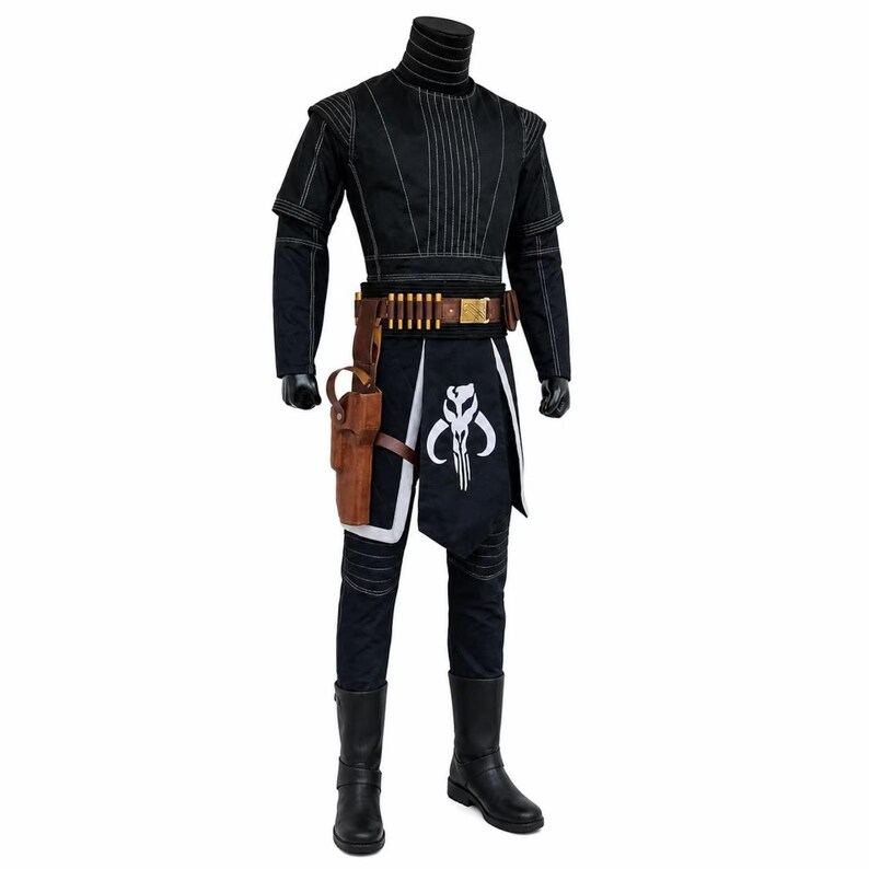 May include: Black costume with white stitching, featuring a high collar and short sleeves. The outfit includes a brown belt with ammunition, a holster, and a black and white apron with a skull emblem. The costume is completed with black boots.