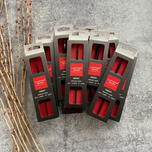 May include: A set of eight black crochet hooks in individual red and black packaging. Each package features the text "Lantern Moon Handcrafted" and lists the size of the hook in US and mm. The hooks are labeled "Ebony Crochet Hook".