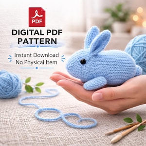 May include: A light blue knitted bunny with black eyes and upright ears. The bunny is held in a hand, with two balls of blue yarn and knitting needles nearby. Text on the image reads "DIGITAL PDF PATTERN" and "Instant Download No Physical Item."