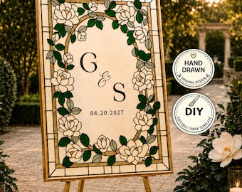 Puede incluir: Un letrero de boda rectangular sobre un caballete dorado con un borde estilo vitral de flores blancas y hojas verdes. El centro muestra las letras G & S y la fecha 06.20.2027 en texto negro. Dos insignias circulares indican un diseño dibujado a mano.