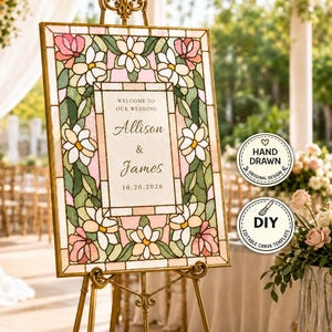 Può includere: Un cartello di benvenuto per matrimonio rettangolare con un bordo in stile vetrata decorato con fiori rosa e bianchi e foglie verdi. Il testo centrale recita: WELCOME TO OUR WEDDING, Allison & James, 10.20.2026. Il cartello è su un cavalletto dorato.