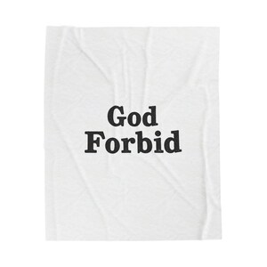 May include: White blanket with the words "God Forbid" printed in bold, black letters. The blanket has a slightly wrinkled texture.