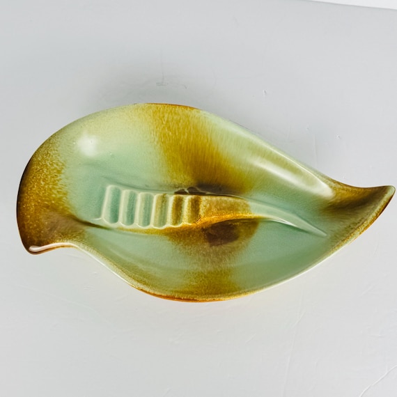 Genuine 1950s Red Wing Pottery ashtray in that perfect atomic-age mint green + brown glaze — a real piece of American mid-century craft history, not a reproduction.