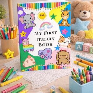 May include: A children's book titled "My First Italian Book" with colourful illustrations of animals and a rainbow. The book is surrounded by crayons, a teddy bear, and other toys, creating a playful learning environment.