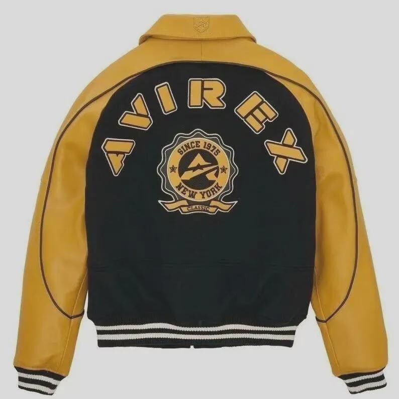 May include: A yellow and black varsity jacket with the word "AVIREX" across the back. The jacket features a "Since 1975 New York Classic" emblem. The jacket has a white and black striped hem.