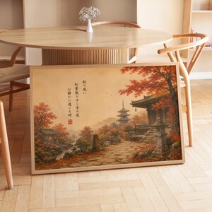 Könnte beinhalten: Ein rechteckiger gerahmter Kunstdruck mit einer Landschaftsmalerei eines japanischen Tempelkomplexes, umgeben von herbstlichen Bäumen mit leuchtend roten Blättern, einem Steinweg, einer Pagode und japanischer Kalligrafie in schwarzer Tinte auf beigem Grund.