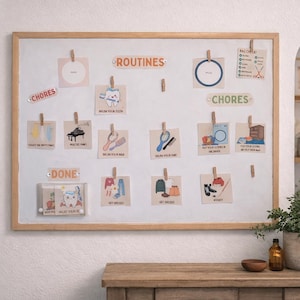 May include: A white framed chore chart with illustrations and text. The chart includes the words "ROUTINES", "CHORES", and "DONE". The illustrations depict various activities such as brushing teeth, playing piano, and getting dressed. The chart is held in place with wooden clips.