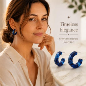 May include: A pair of blue hoop earrings with a marbled pattern. The earrings are circular with a gap, featuring a glossy finish. Text on the image reads: Timeless Elegance, Effortless Beauty Everyday. The earrings are made of resin.