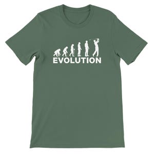 May include: Green t-shirt with a white graphic depicting the evolution of man, culminating in a golfer swinging a club. The word "EVOLUTION" is printed in white below the figures. The shirt is made of a soft material.