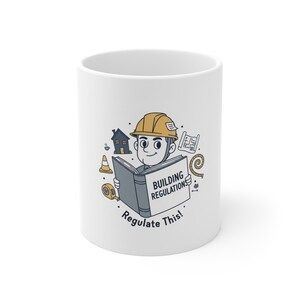 May include: White ceramic mug with a cartoon construction worker reading a book labelled "BUILDING REGULATIONS." The mug features illustrations of a house, blueprints, and a measuring tape. The text "Regulate This!" is also included.