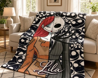 May include: A soft throw blanket featuring a split-face character design with red hair and a stitched face on one side, and a skeletal face in a pinstripe suit on the other. The background has a black and white skull pattern with the name Lila.