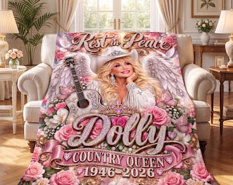 May include: A plush throw blanket featuring a portrait of a blonde woman in a white cowboy hat and fringed jacket, surrounded by angel wings, a guitar, and pink roses. Text reads: Rest in Peace, Dolly, COUNTRY QUEEN, 1946-2026, with heart accents.
