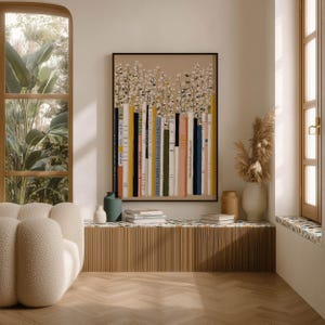 Stylish art print of a whimsical bookshelf and daisy garden in soft neutrals, hanging above a ribbed bench with books and vases by arched windows.