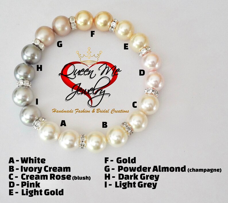May include: A pearl bracelet with a colour gradient, from white to light grey, with shades of cream, pink, and gold. Rhinestone spacers separate the pearls. The bracelet is from Queen Me Jewelry.