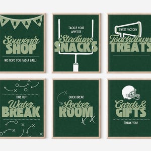 May include: Set of six framed signs with a green background and white and green text. The signs have a football theme, with phrases like "Souvenir Shop," "Stadium Snacks," and "Touchdown Treats."