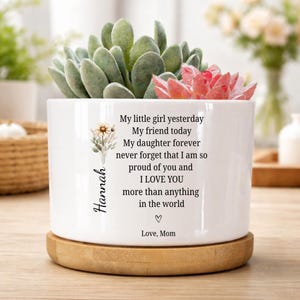 May include: White ceramic planter with a wooden base, featuring a succulent arrangement. The planter has text that reads "My little girl yesterday...I LOVE YOU more than anything in the world." The name "Hannah" is also printed on the planter.