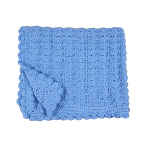 May include: A light blue, crocheted blanket with a scalloped edge. The blanket is folded over, revealing the textured stitch pattern. The soft, handmade blanket is a cozy item.