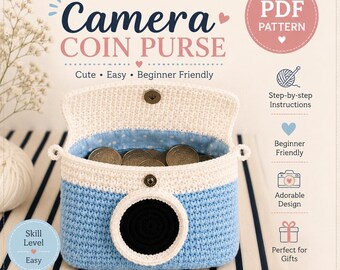 May include: A crochet pattern for a camera coin purse. The purse is blue and white with a black lens detail. The text on the image says "Camera Coin Purse" and "Make your own mini camera coin purse!"
