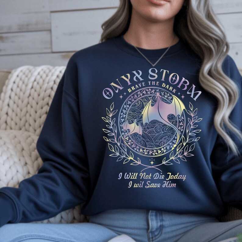 A woman wearing a navy blue sweatshirt with a dragon design and text printed on it.