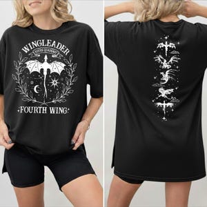A woman wearing a black t-shirt with a graphic design featuring a dragon and stars.