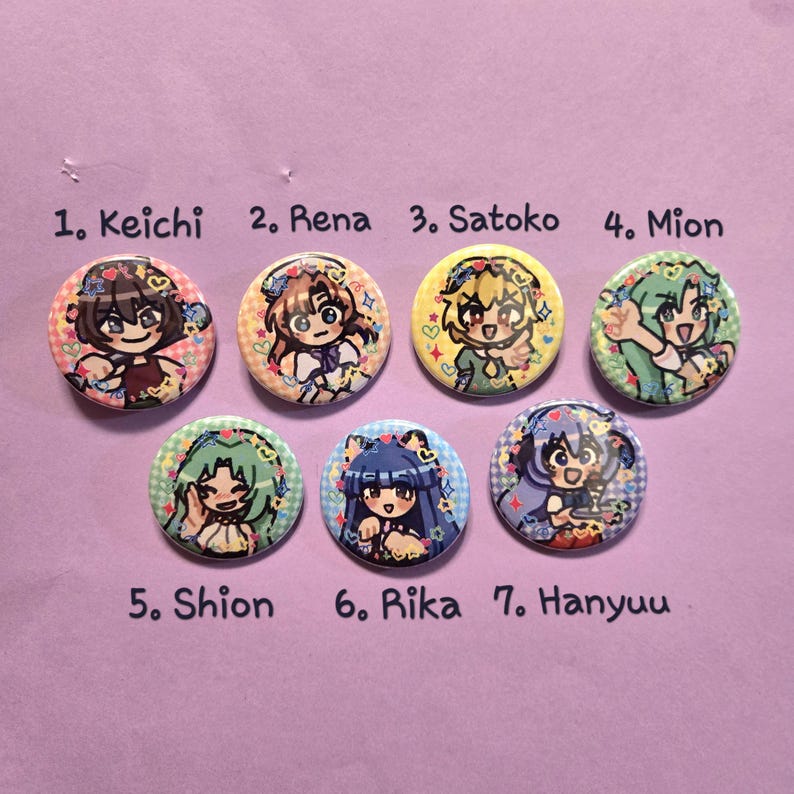 May include: Seven colorful round buttons featuring anime-style character illustrations. Each button has a different character design, with names like "Keichi," "Rena," and "Satoko" printed above. The buttons are arranged on a light purple surface.