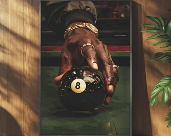 May include: A framed print featuring a close-up of a hand with gold jewelry holding a black eight ball. The ball has a white number eight. The background is a green pool table.