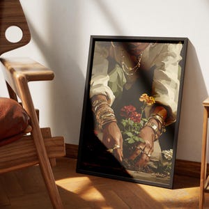 May include: A framed art print depicts a person tending to flowers. The person is wearing gold jewelry and a light-colored shirt. The flowers are red and yellow. The frame is black.