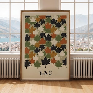 May include: A framed art print with a repeating pattern of maple leaves in black, green, orange, and white. The leaves are set against a beige backdrop, with Japanese text at the bottom. The frame is made of wood.