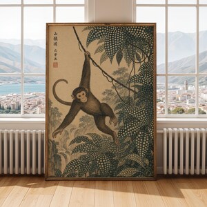 May include: A framed vintage print featuring a monkey hanging from a vine in a jungle setting. The artwork is in shades of brown and green, with Japanese text in the upper left corner. The print is displayed in a room with a city view.