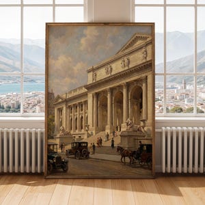 May include: A framed vintage painting depicts a grand neoclassical building with columns, statues, and a wide staircase. Antique cars and a horse-drawn carriage are on the street. The artwork is in a wooden frame and leans against a window.